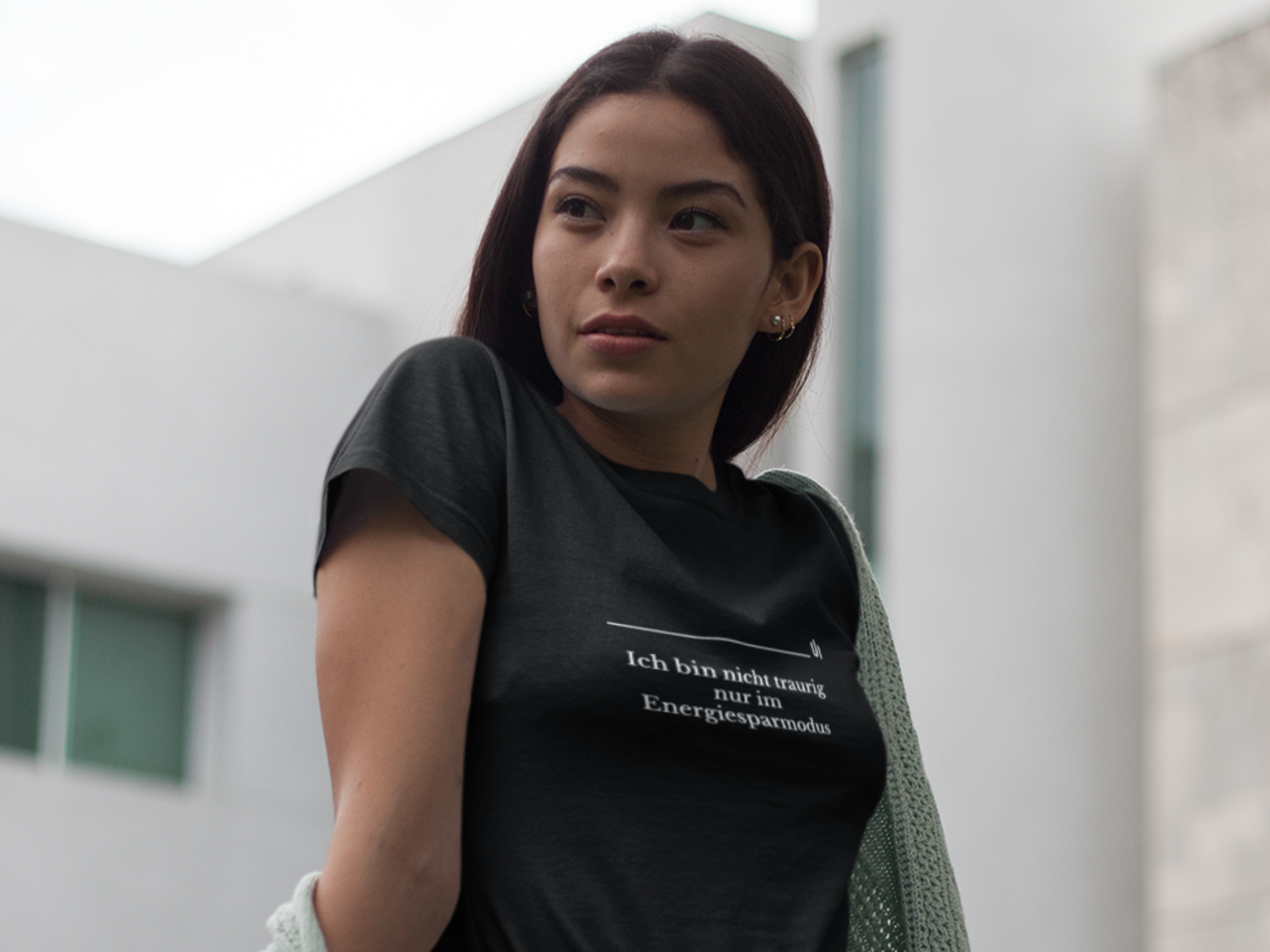Woman wearing a black t-shirt with text in an urban setting