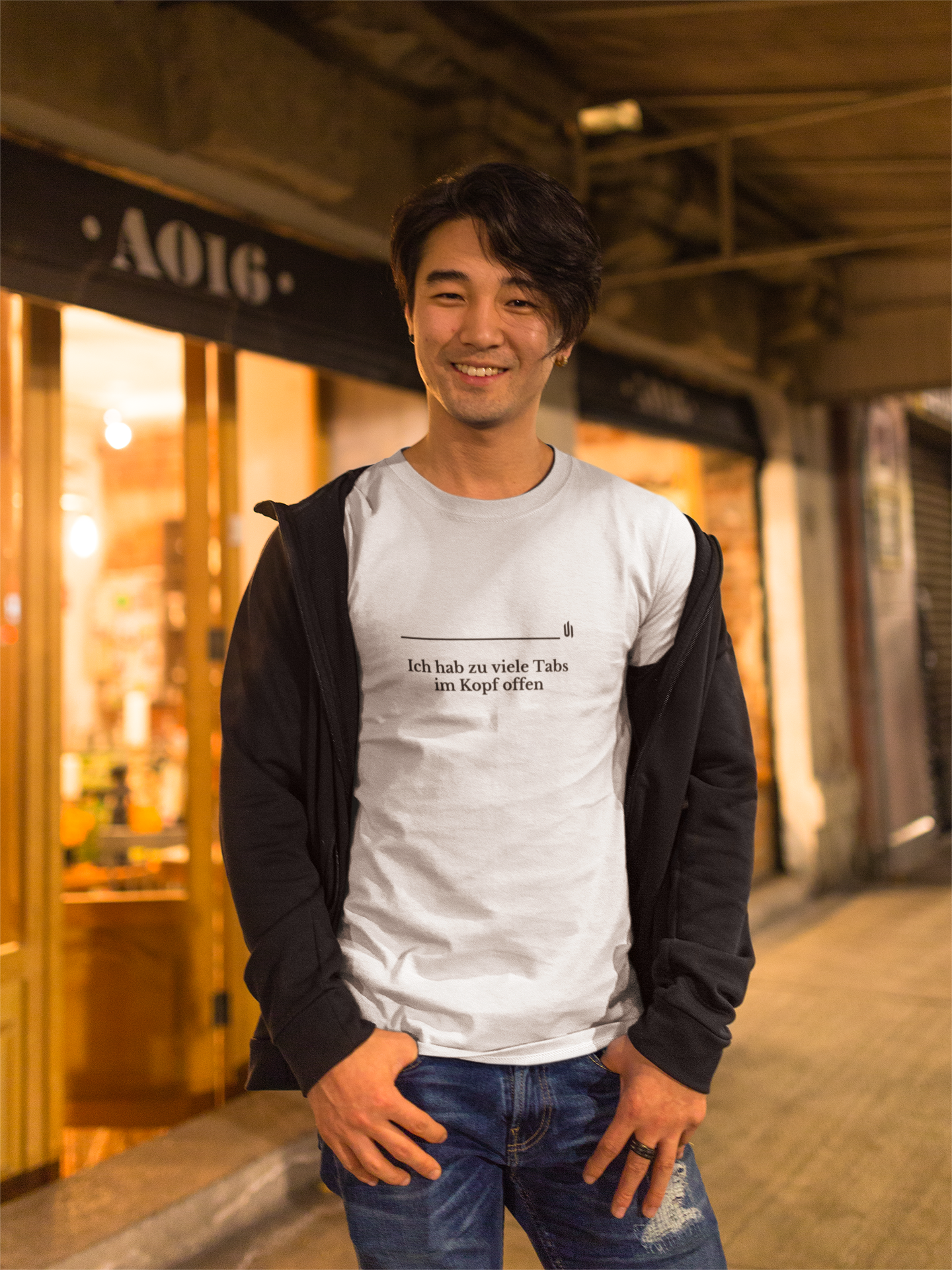 Man wearing a white t-shirt with text in an urban setting
